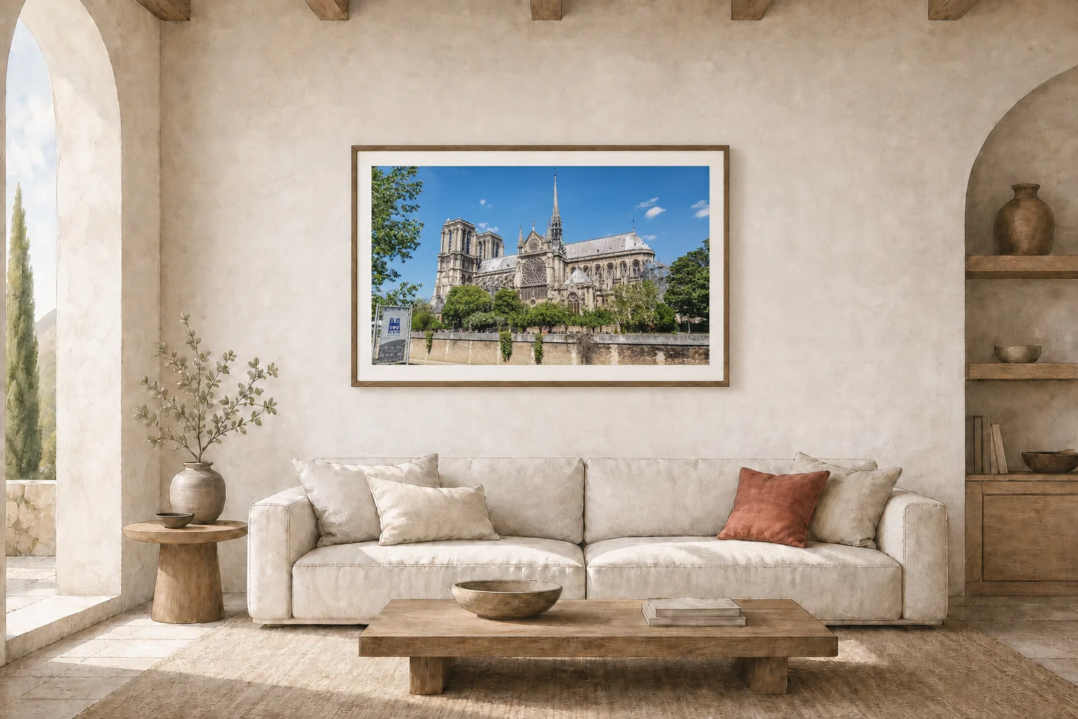 A framed Notre-Dame photograph displayed above a sofa