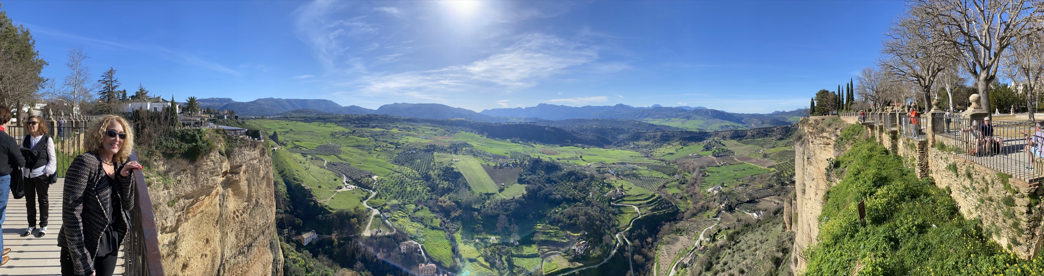 A panoramic view across the Ronda gorge and green Andalusian mountains